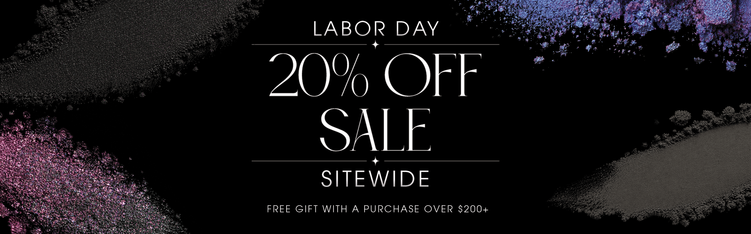 Labor Day 20% Off Sale Sitewide. Free gift with a purchase over $200+. Text set against a black background scattered with shimmering purple, blue, and pink cosmetic powder pigments.